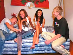 Two guys have groupsex with two amazing cuties on the sofa